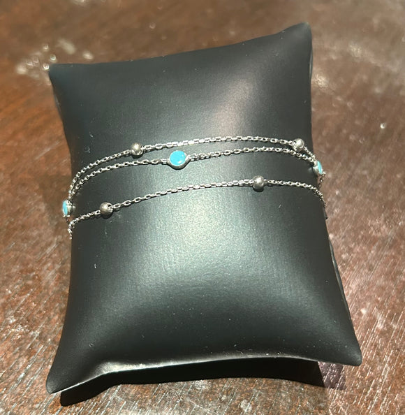 Triple chain bracelet with light blue beads